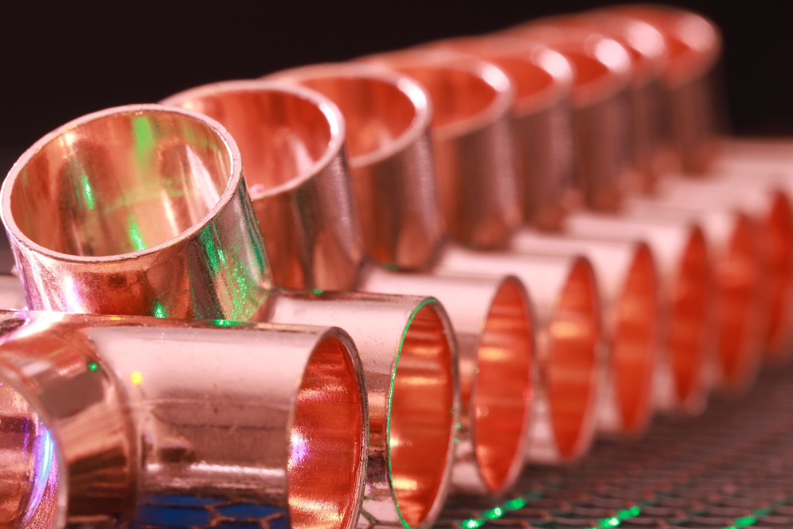 A row of copper pipe fittings lined up