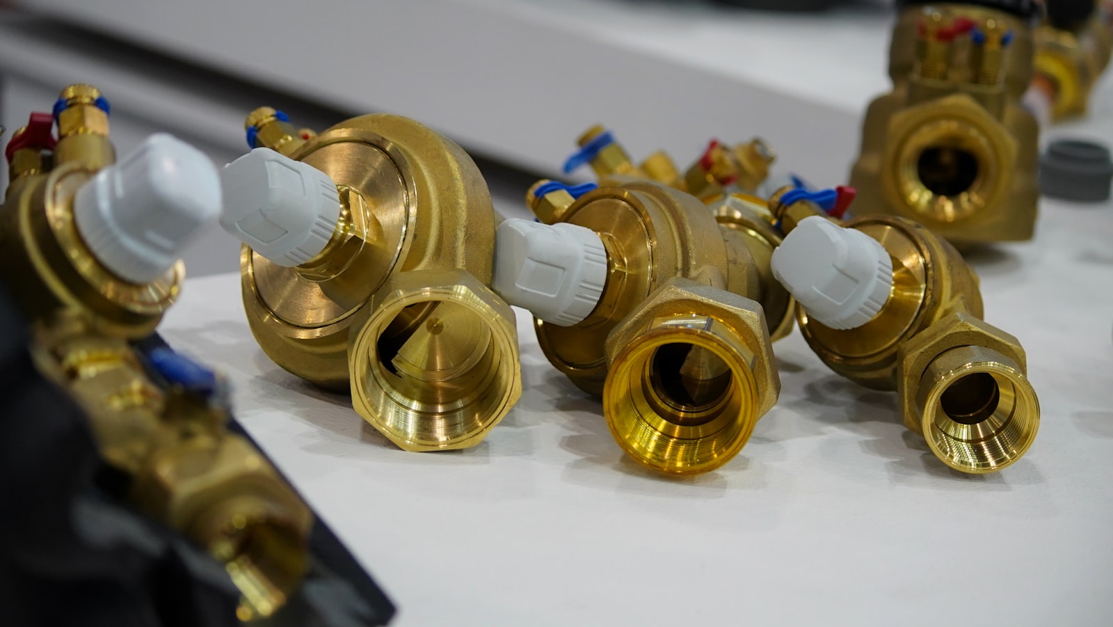 Brass valves fitted with white thermostatic control heads